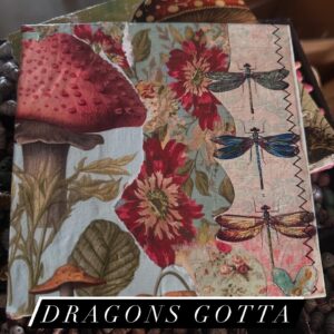 Three dragonflies stacked on the right side of the board, red flowers, and a very large red-capped mushroom on the right side.