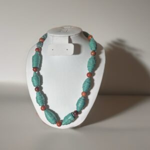 Stone look paper beads that are deep green and alternating with round wooden beads on a white form and a neutral background.