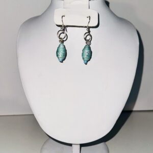 Earrings with silver fixings with blue and silver beads on a neutral background