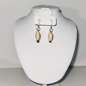 Butter yellow dangle earrings with a barrel shape that slopes into a teardrop shape with a neutral background l
