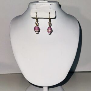 Delicate earrings of soft pink and white with a small white seed bead at the bottom and gold fixings on a neutral background.