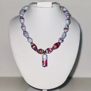 Necklace of Blue based paper beads with patterns of florals primarily in red, deep pink, yellow and green