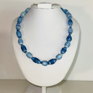 Necklace of paper-based beads in colors of dark blue denim, acid wash denim and light wash denim, on a white form with a neutral background