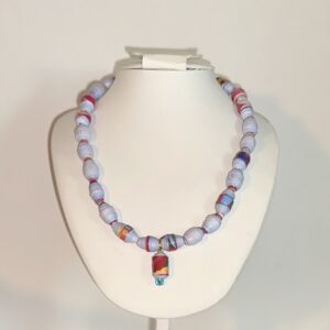 Blue beads with a variety of colors and flowers splattered throughout, on a white form with a neutral background