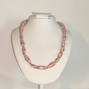 Retro Corals paper bead necklace on a white form with a neutral background