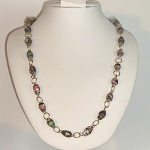 Small black beads with pinks with silver fixings on a white form with a neutral background