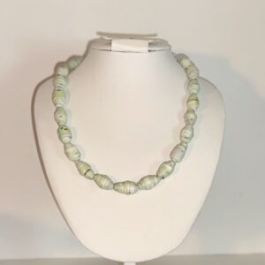 Short necklace of sea blue beads on a. white form with a neutral background