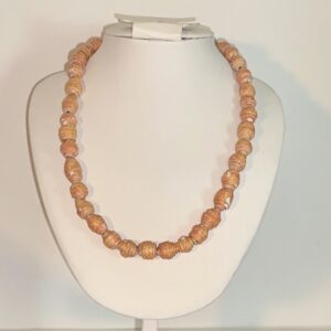 Paper beads in a Bollywood orange on a white form with a neutral background