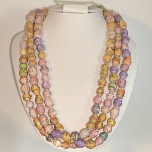 Three layer bead necklace in Bollywood colors on a white form with a neutral background