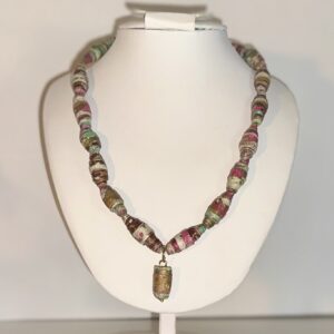 Necklace of jewel toned pinks and blues with a matching artist created charm on a white form with a neutral background