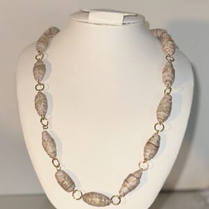 Necklace of paper beads that look like wood with gold fixings on a white form with a neutral background