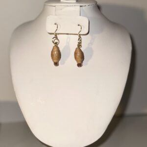 Tan colored dangle earrings with teardrop shaped paper-based beads, gold fixings on a neutral background
