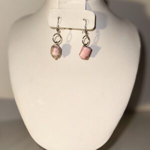 Short Pink Cylinder Earrings with silver fixings on a neutral background