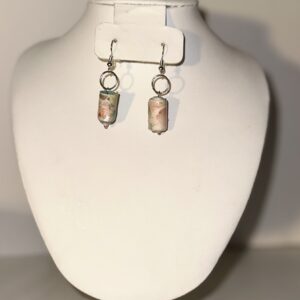 Antique Look Pink & Blue Cylinders with lace pattern with silver fixings on a neutral background