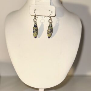 Dangle earrings made of paper based beads with a gold/green base with blue and white in a Venetian Glass design with silver fixings on a neutral background