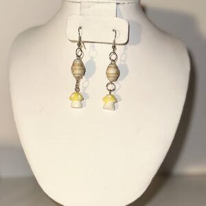 Earrings with silver fixings and ovals of beige with yellow strips around and a second tier of yellow capped white mushrooms