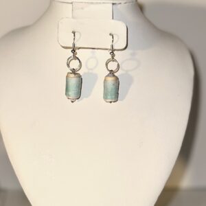 Baby blue and yellow cylinder shaped earrings with solving fixings on a neutral background