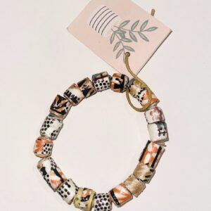 Bracelet of paper beads made from paper with an Asian scene on a neutral background