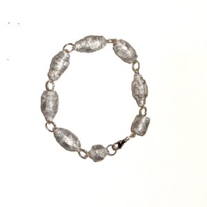 Bracelet of silver and white paper-based beads covered with silver glitter and connected by silver fixings on a white background