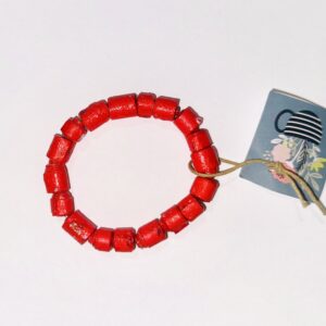 Red 'leather look' bracelet on a neutral blue background